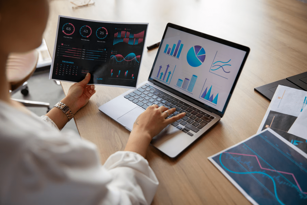 A professional is looking at different charts, graphs, and metrics to measure business performance and outcomes